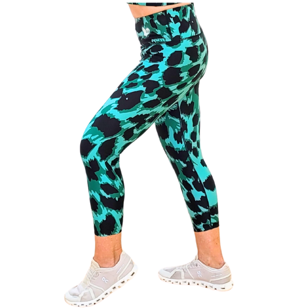 Emerald Green and black leopard print patterned leggings worn by a person on a white background