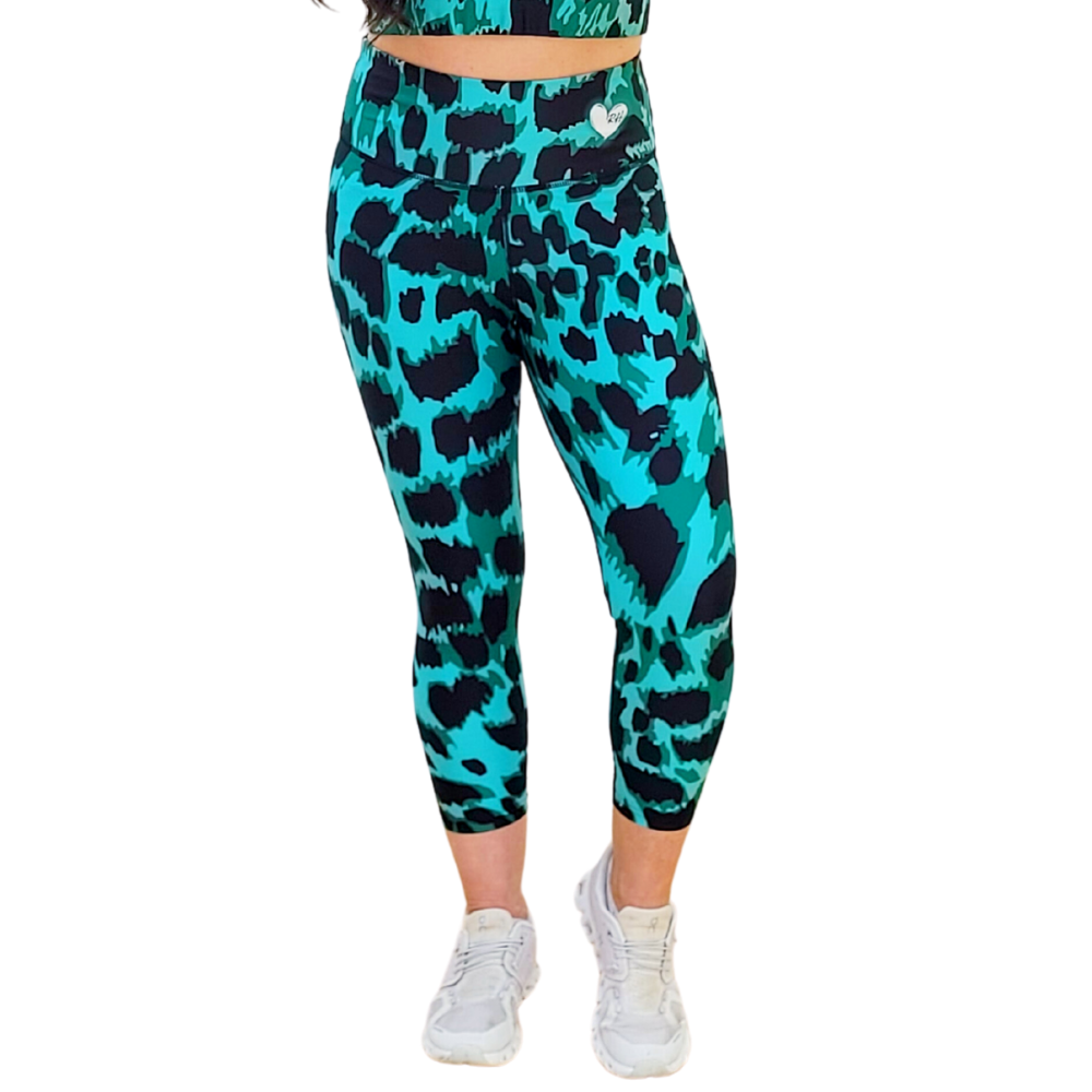Emerald Green and black leopard print leggings worn by a person on a white background