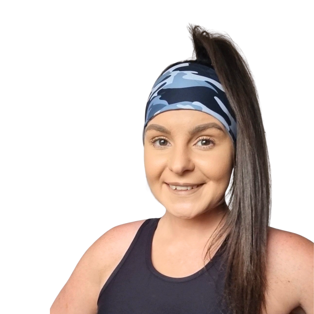 Woman wearing a grey and blakc camouflage headband with a white background