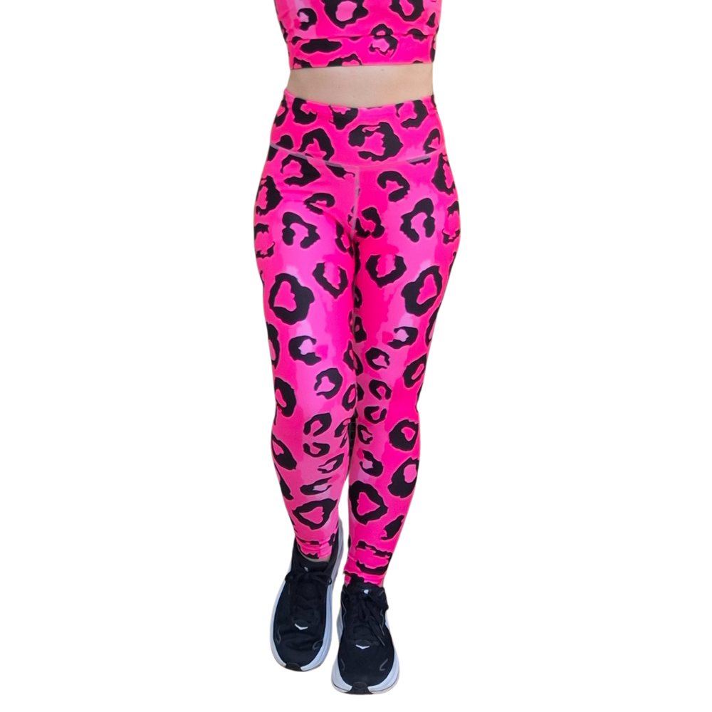 Neon Pink leopard print leggings with black shoes on a white background