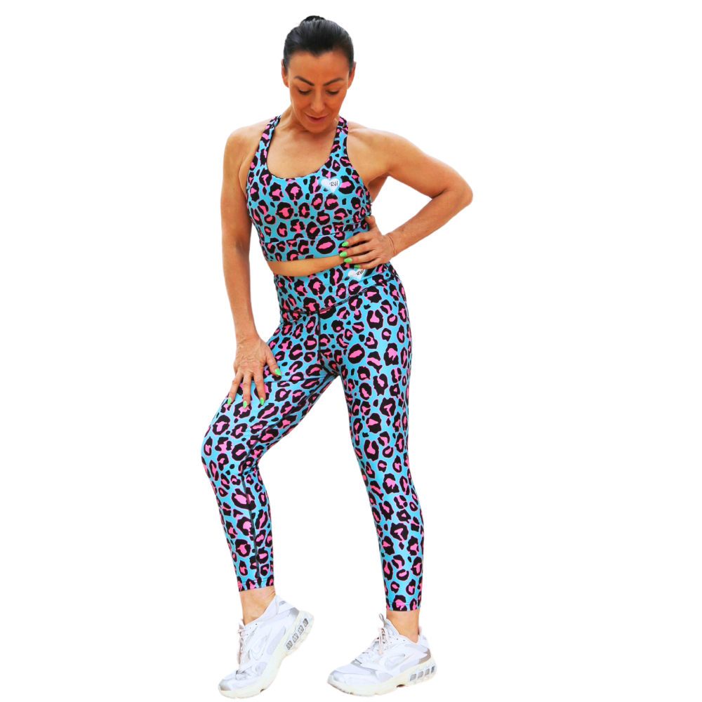 Woman wearing a blue leopard print sports outfit on a white background