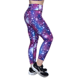 Person wearing purple and pink disco ball leggings on a white background