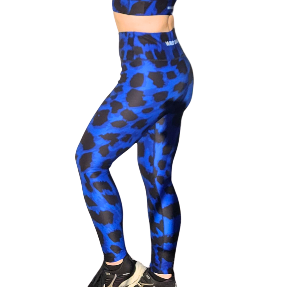 Blue and black leopard print patterned leggings worn by a person on a white background