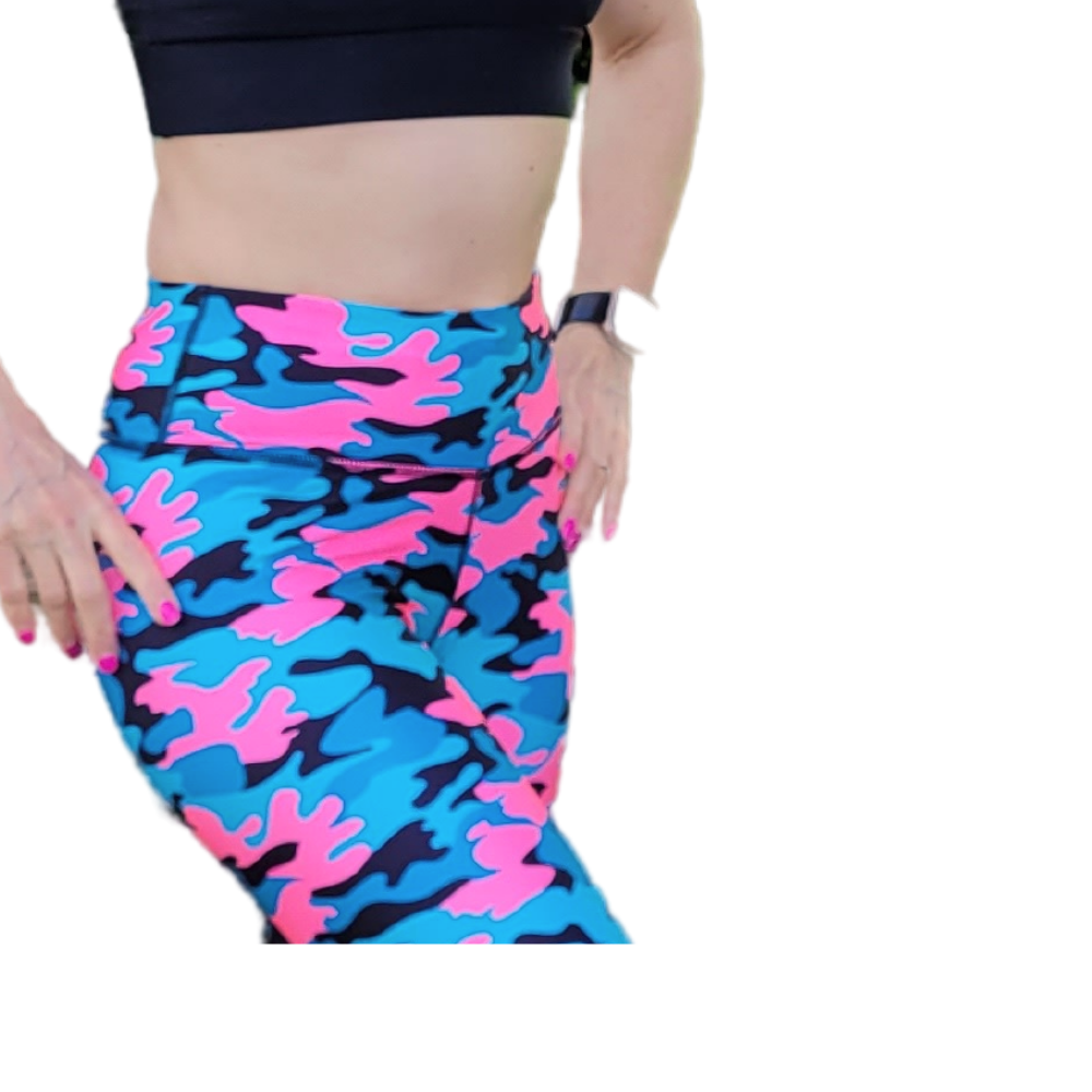 Blue and pink camouflage leggings worn by a person on a white background