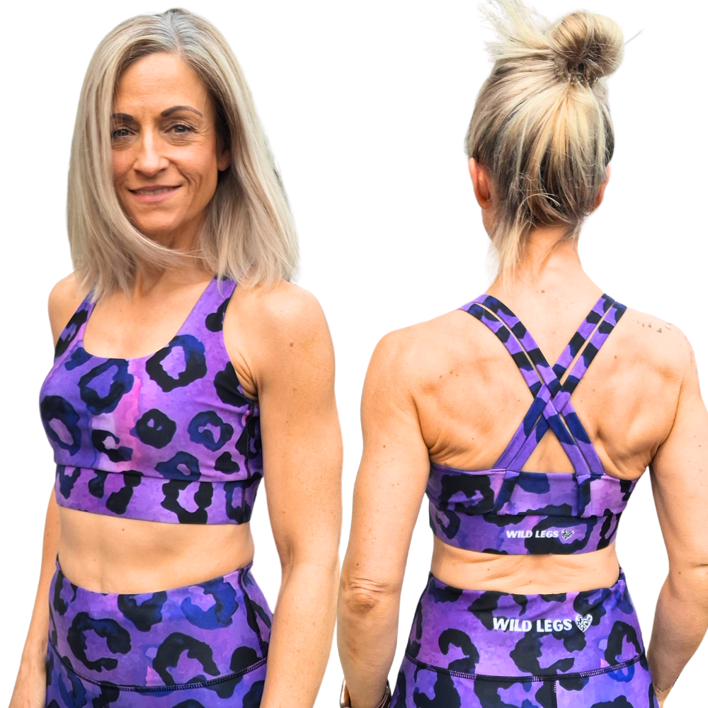 Woman wearing purple and black leopard print sports bra showing Wild Legs branding. Front and racer back view