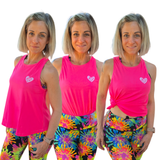 Woman wearing a pink tank top and tie-dye leggings with a heart logo on a white background