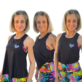 woman wearing a black tank with a white heart logo in three different styles with bright leggings
