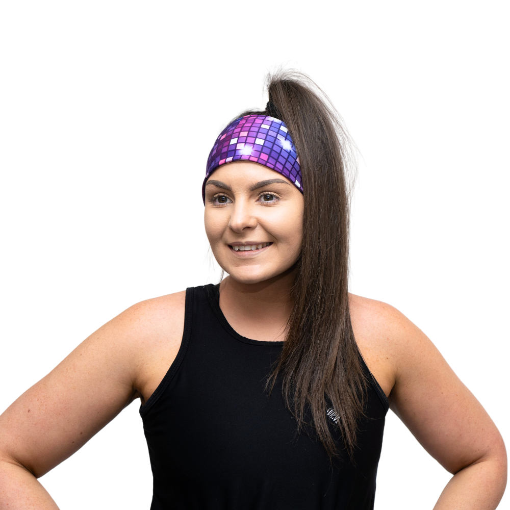 Woman wearing a black tank top and a colorful headband on a white background