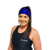 Woman wearing a black tank top with 'Wild Legs' logo and a blue patterned headband on a white background