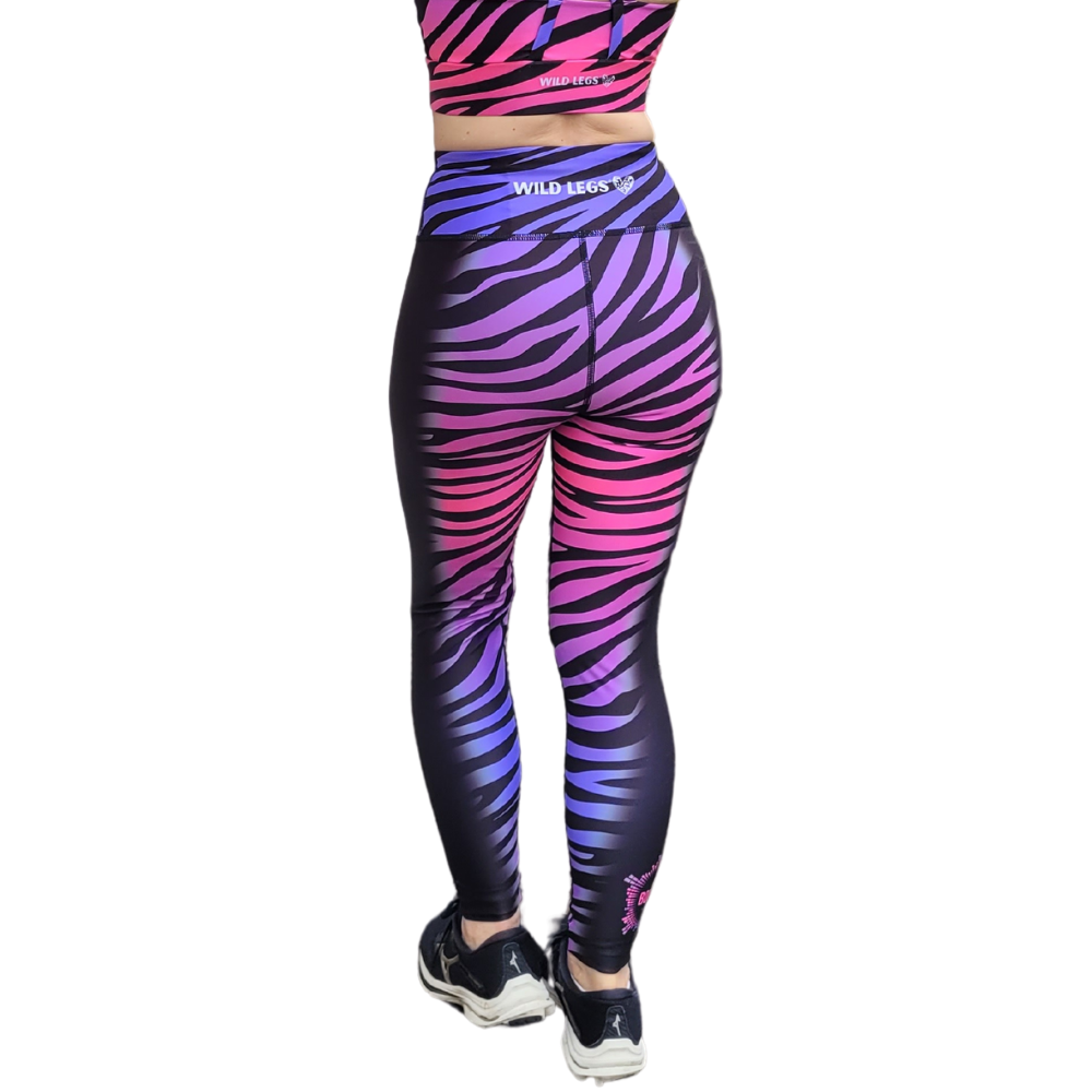 Zebra print leggings with a gradient of purple and pink on a white background