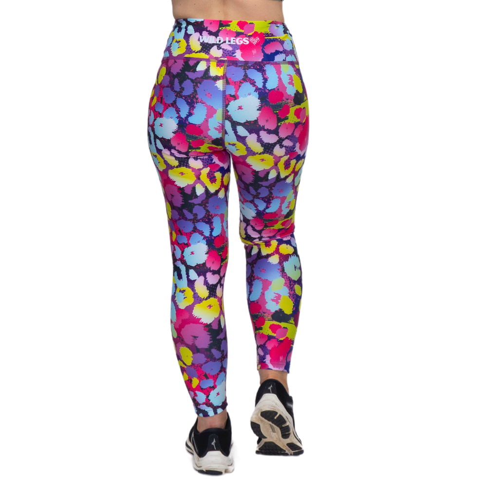 Colorful patterned leggings worn by a person on a white background