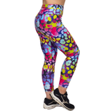 Colorful patterned leggings worn by a person on a white background