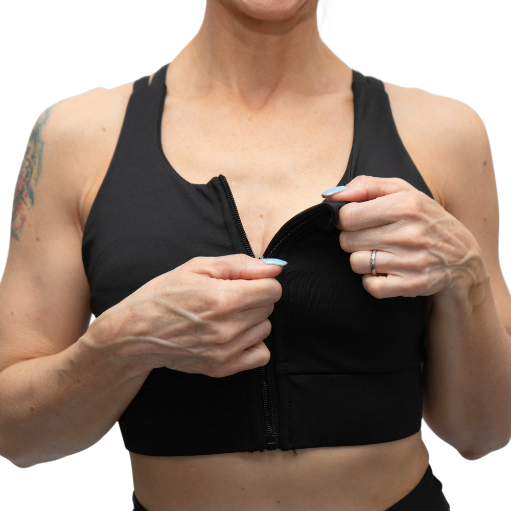 Person wearing a black sports bra with a white background