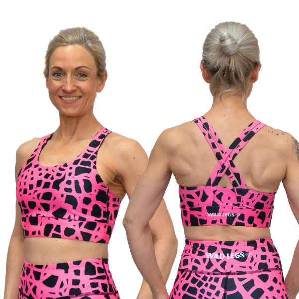 woman wearing pink and black patterned sports bra showing front and back view with Wild Legs branding