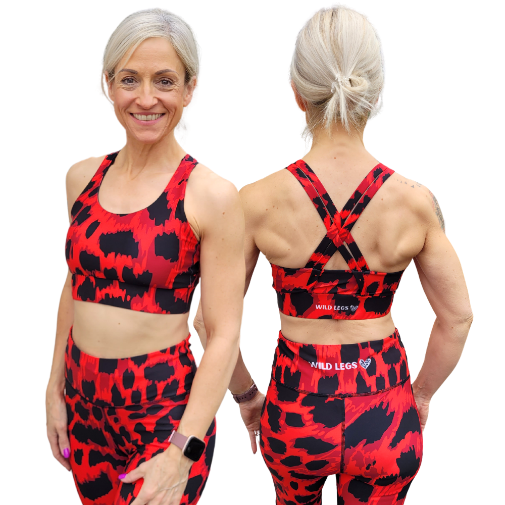 woman wearing red and black animal print design sports bra, shown from the front and the back