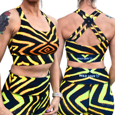 Front and back view of a woman wearing a matching sports bra and leggings set with a vibrant yellow and black tribal pattern