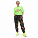 Person wearing a bright green 'I Feel So Good' t-shirt and colorful patterned pants on a white background