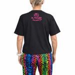 Person wearing a black t-shirt with colourful pants on a white background