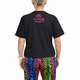 Person wearing a black t-shirt with colourful pants on a white background