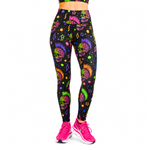 A person wearing black leggings with a colourful neon-style sugar skull and star pattern, paired with bright pink trainers, shown against a plain white background.