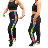 Black athletic outfit for festivals with colourful neon leopard print side panels worn by a person on a white background