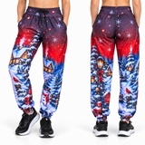 Christmas Joggers shown from the front and back with a festive snowy scene worn with black trainers on a white background