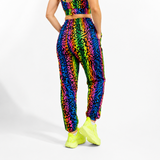 Person wearing a colorful animal print outfit with neon shoes on a white background