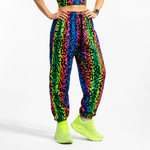 Colorful zebra-patterned jogger pants worn by a person on a white background