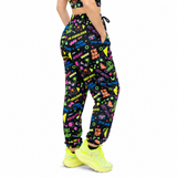 Person wearing colourful patterned pants with neon shoes on a white background
