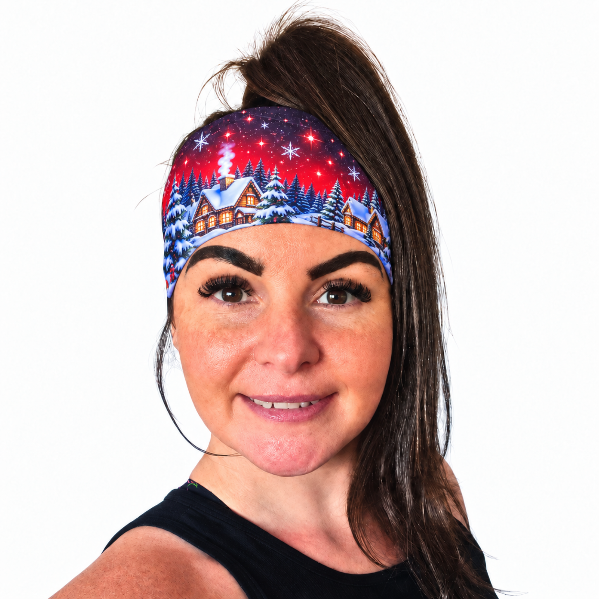 Woman with dark hair wearing a christmas design headband in red with snowy trees and red skies on a white background