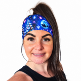 Christmas Headband in Blue, snowflakes and christmas trees worn by a model with dark hair on a white background