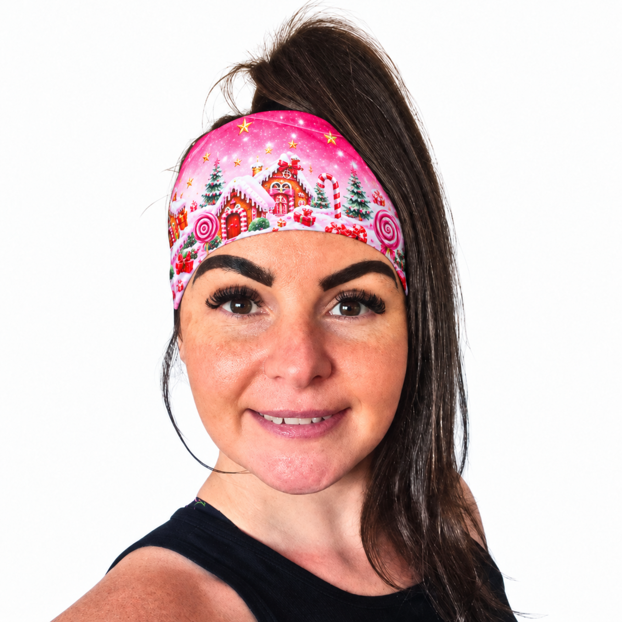 Woman with dark pony tail wearing a pink head with a Christmas candy cane design on a white background