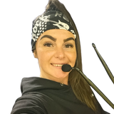 Rockstar print headband on a women wearing a head mic in a black hoodie on a white background holding drum sticks