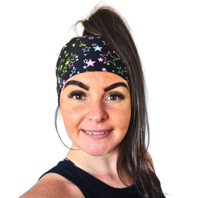 Woman wearing black headband with a start pattern on a white background
