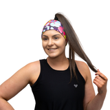 woman in a black vest top wearing a bright coloured headband on a white background