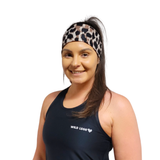 woman wearing leopard print headband on a white background