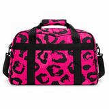 Pink and black animal print holdall bag on a white background