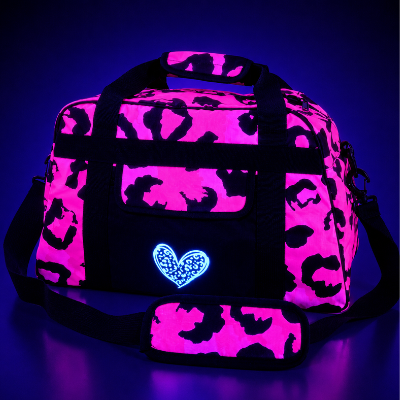 Pink and black animal print patterned holdall bag with a blue heart design on a dark background