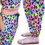 Colorful leopard print pants worn by a person, with a focus on the pattern and design.