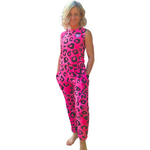 Woman wearing a pink leopard print jumpsuit on a white background