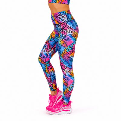 A person wearing bright multicolor patterned leggings and pink running shoes, shown from the waist down against a plain white background.