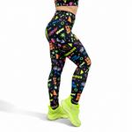 Colorful patterned leggings with neon green shoes on a white background