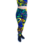 Colourful abstract, swirl-patterned leggings worn by a person on a white background