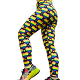 Leggings with rainbow heart pattern worn by a person on a white background