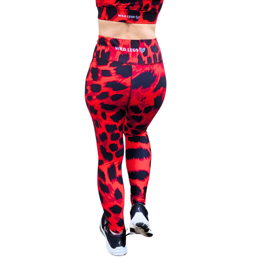 Red and black leopard print patterned leggings with a visible brand logo on a white background