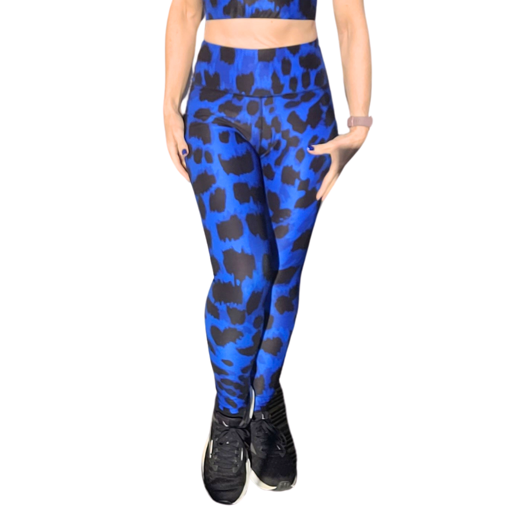 Person wearing blue and black leopard print patterned leggings on a white background