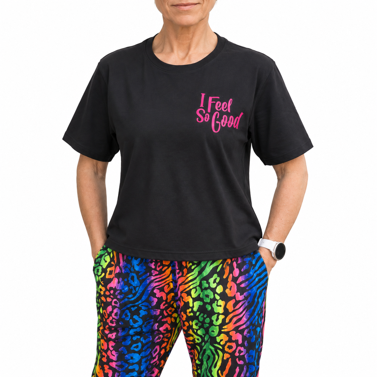 Person wearing a black t-shirt with 'I Feel So Good' text and colorful leopard print pants.