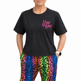 Person wearing a black t-shirt with 'I Feel So Good' text and colorful leopard print pants.