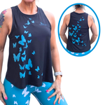 Woman wearing a black sleeveless top with blue butterfly patterns, shown front and back.