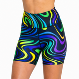 Ladies Fitness Shorts in a Blue, Black, Yellow and Purple Swirl pattern on a black base, shot on a woman on a white background